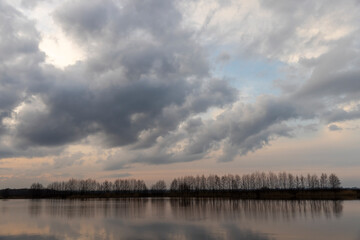 a beautiful reflection of the sky and clouds in the lake at sunset