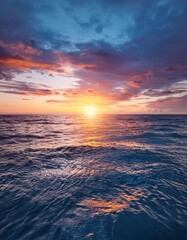 Obraz premium A vibrant and colorful ocean sunset, captured with a wide-angle lens on the water