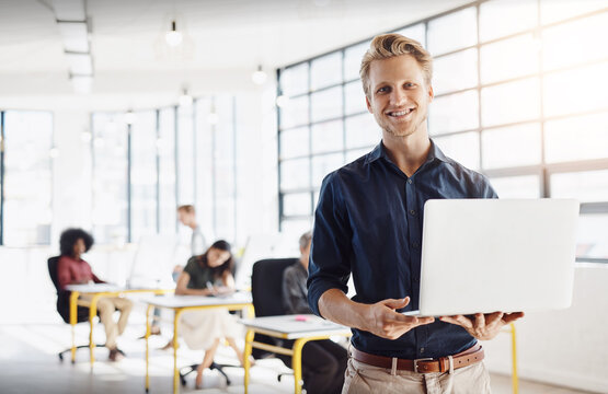 Design, office and portrait of man with laptop, coworking space and confidence in erp planning. Research, agenda and creative professional on website for online project development at digital agency