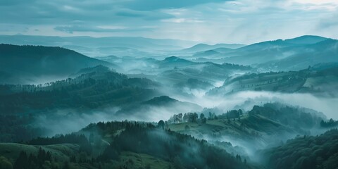Naklejka premium A misty landscape with mountains obscured by fog