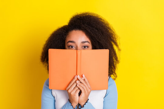 Photo portrait of attractive young woman read book cover face dressed stylish blue clothes isolated on yellow color background