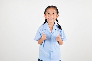 Portrait smiling Asian little girl kindergarten giving thumbs up studio shot isolated white background, good job feedback, woman kid wearing school uniform, back to school concept