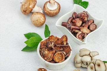 Assortment of various mushrooms - fresh, dried and pickled. Oyster, cremini, porcini and shiitake