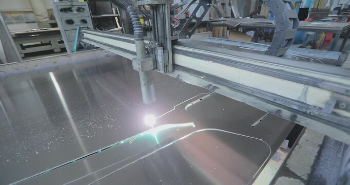 Plasma cutting. Plasma cutter work at the factory. The plasma cutter will cut the part. The process of cutting a metal part with a plasma cutter