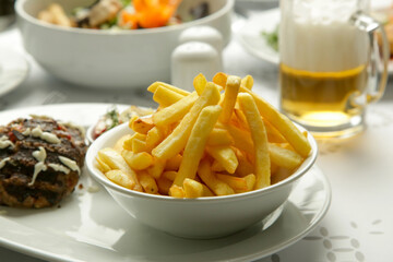 Tender mincemeat grilled with spices served with french fries and chilli peppers
