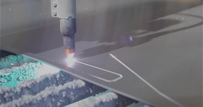 Plasma cutting. Plasma cutter work at the factory. The plasma cutter will cut the part. The process of cutting a metal part with a plasma cutter
