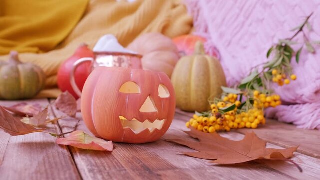 autumn Yellow Leaves, pumpkin, orange pyracantha Berries on table, Halloween preparation, Jack-o'-lantern candlelight, Autumn Decor and Creativity