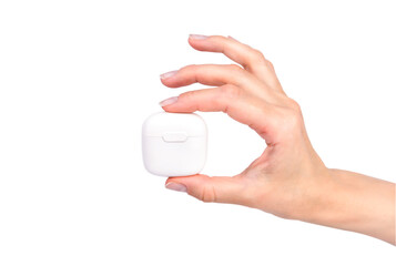 Female hand holding wireless headphones isolated on white background. Bluetooth headphones.
