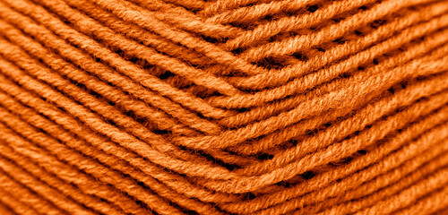 The texture of the wool is dyed orange. Abstract background. Close-up.