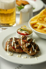 Tender mincemeat grilled with spices served with french fries and chilli peppers