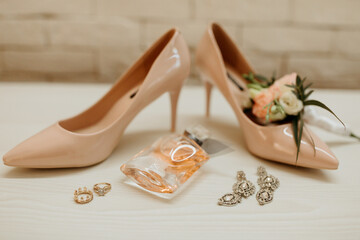 A pair of high heels and a bottle of perfume are displayed on a table. Concept of elegance and sophistication