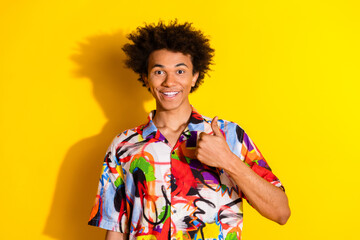 Photo of nice young man show thumb up wear shirt isolated on bright yellow color background