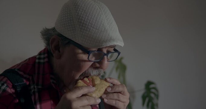 FOOD LOVER SERIES:
Grandpa approving a meal made by his grandson. Veteran cook giving culinary verdict on a focaccia. in the foreground he enjoys the bite but analyzes it closely. Cook awaits aproval.