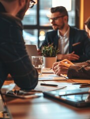 People gathered around a wooden table for a meeting or discussion, perfect for corporate or social media use