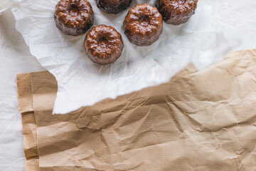Caneles de bordeaux - traditional French sweet dessert with table background,Cannelés Recipe,small pastry rum and vanilla on a wooden plate,close up,french food,french cuisine,French Tourism,olympic