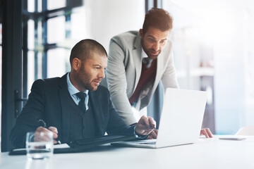 Fototapeta premium Businessmen, laptop and problem solving for collaboration in office, accounting agency and discussion for project. Teamwork, support and mentorship with internship, planning and deadline for finance