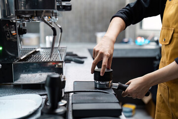 Barista Preparing Espresso with Professional Coffee Machine in Modern Cafe