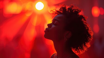 A serene moment of contemplation captured as a young person enjoys a peaceful moment amidst the vibrant red ambiance of a dreamy, demure setting