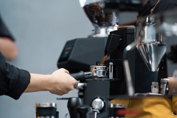 Barista Preparing Fresh Coffee Using Professional Espresso Machine in Modern