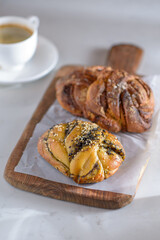 Cup of coffee and pastries on a minimalist coffee shop table. Coffee shop lifestyle. Selective focus.