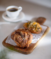 Cup of coffee and pastries on a minimalist coffee shop table. Coffee shop lifestyle. Selective focus.