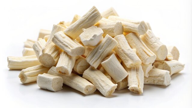 Soft focus image of creamy white sliced marshmallow root althaea officinalis forms a delicate heap on a pure white background.