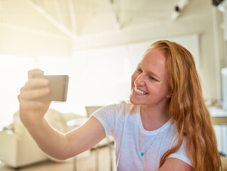 Home, selfie and woman with cellphone, smile and moment with light, happiness and social media. Person, apartment and girl with smartphone, mobile user and photography with digital app and picture