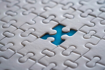 White puzzle with one piece missing, revealing blue background underneath