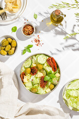 green salad with olives, olive oil, cucumbers and cheese