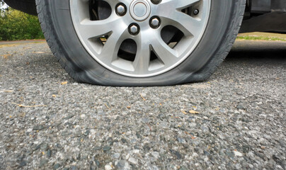 Car flat tire on the rural road. © toa555