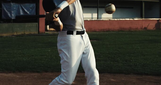 Super slow motion close up of baseball player batter hitting baseball ball with bat during competition game match on baseball stadium at 1000 fps.