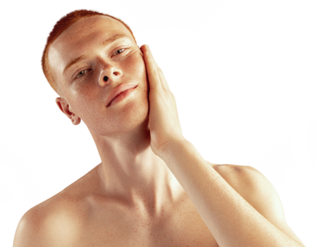 Portrait of young red-haired man posing shirtless against transparent background. Freckled face. Concept of men's health, lifestyle, beauty, body and skin care. Model looking at camera