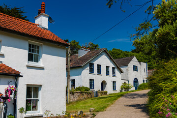 Colourful ancient houses on the main street of Caldey Island, Wales
