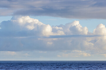 Seascape showing cloudy sky above sea, space for text, winter sunny day, UK England