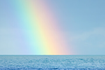 The end of the rainbow out to sea,  no people, space for text, sunny bright clear day, UK England