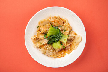 Portion of appetizing asian wonton dumplings with bok choi