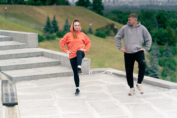 in the park a young couple in love doing sports couples warming up healthy lifestyle synchronized...