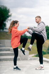 in the park a young couple in love doing sports couples warming up healthy lifestyle synchronized...
