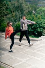 in the park a young couple in love doing sports couples warming up healthy lifestyle synchronized...