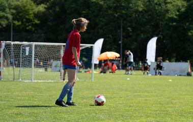 Obraz premium Small Footballer At Summer Match Shows Great Potential