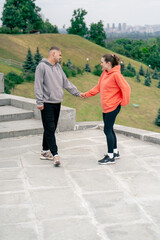 in the park a young couple in love doing sports couples warming up healthy lifestyle synchronized...