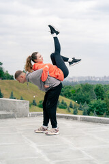 in the park a young couple in love doing sports couples warming up healthy lifestyle synchronized...