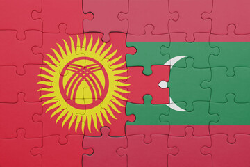 puzzle with the colourful national flag of kyrgyzstan and flag of maldives .