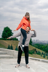in the park young couple in love doing sports couples warming up a healthy lifestyle synchronized...