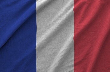 France flag depicted on folded wavy fabric of old cloth close up