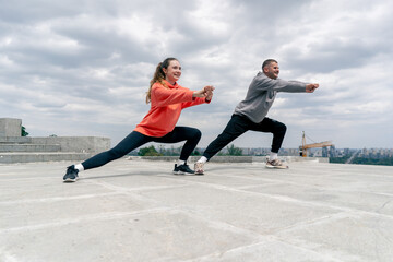 in the park a young couple in love doing sports couples warming up healthy lifestyle synchronized...