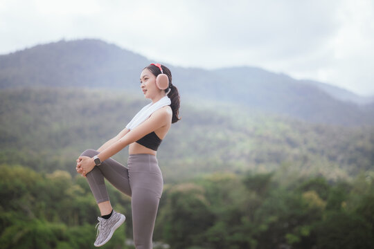 A beautiful woman jogs alone in the city, drinking water. Embracing an active lifestyle, she runs with energy and joy, showcasing fitness, health, and endurance, enjoying the outdoors and nature's bea
