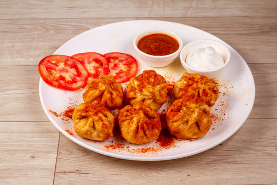 Homemade chicken peri peri momos with sauces and mayonnaise