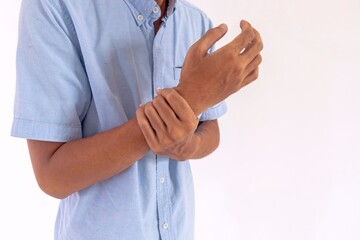 Man holding his wrist due to arthritis or carpal tunnel syndrome