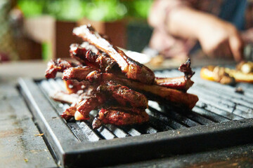 Close-up of lamb on the bone lying on the grill grate